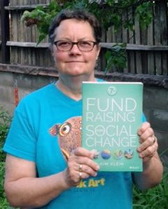 Kim Klein proudly displays the latest edition of her popular fund-raising book.