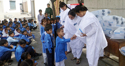 The Pakistan Sisters distribute water bottles and supplies purchased with donations from Loretto-sponsored schools in the United States. (Photo courtesy of Pakistan Sisters)
