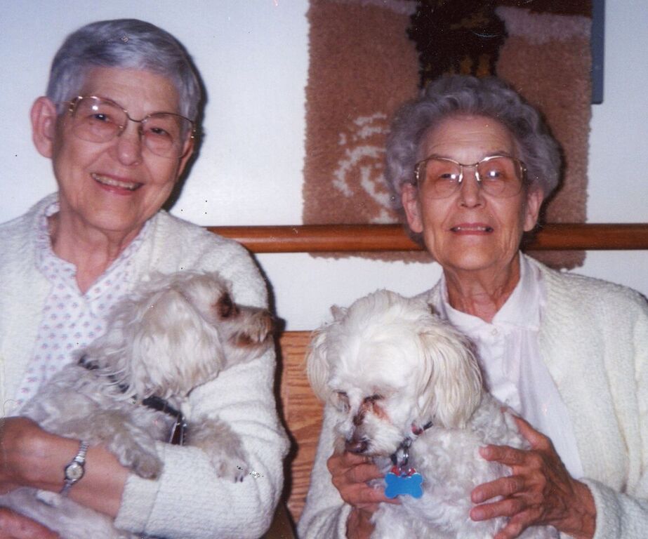 Puppy Love! — Using trick photography, from left siblings Theresa Louise and Bernardine Wiseman both hold the same puppy — Buffy. (Photo courtesy of Loretto Archives)