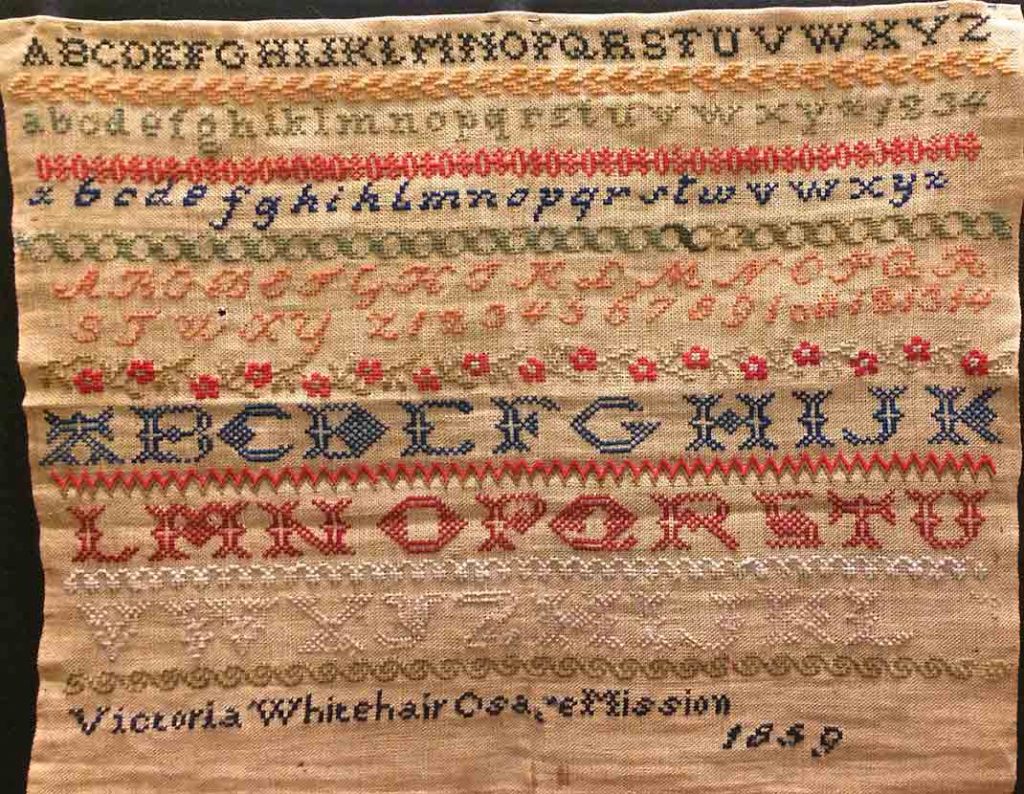 1859 needlework sampler by Victoria Whitehair, age 12, a student at the Osage Mission in Kansas.