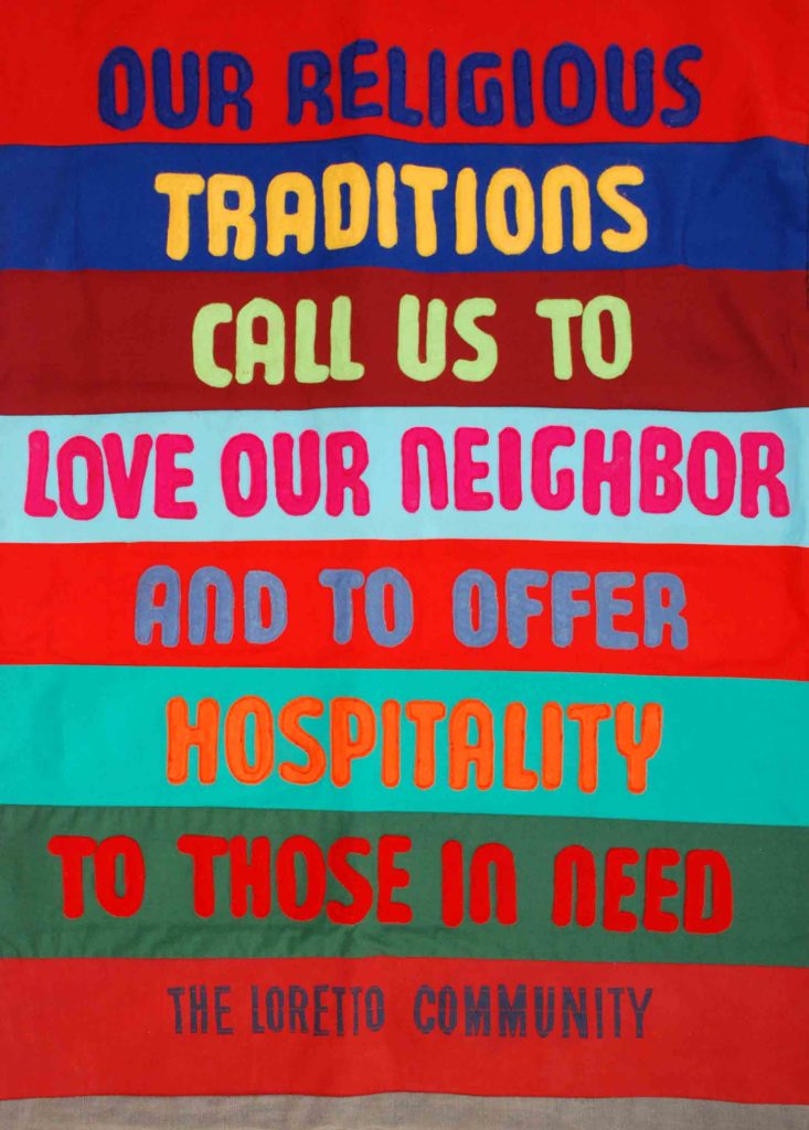 Colorful banner reads "Our religious traditions call us to love our neighbor and to offer hospitality to those in need. The Loretto Community"