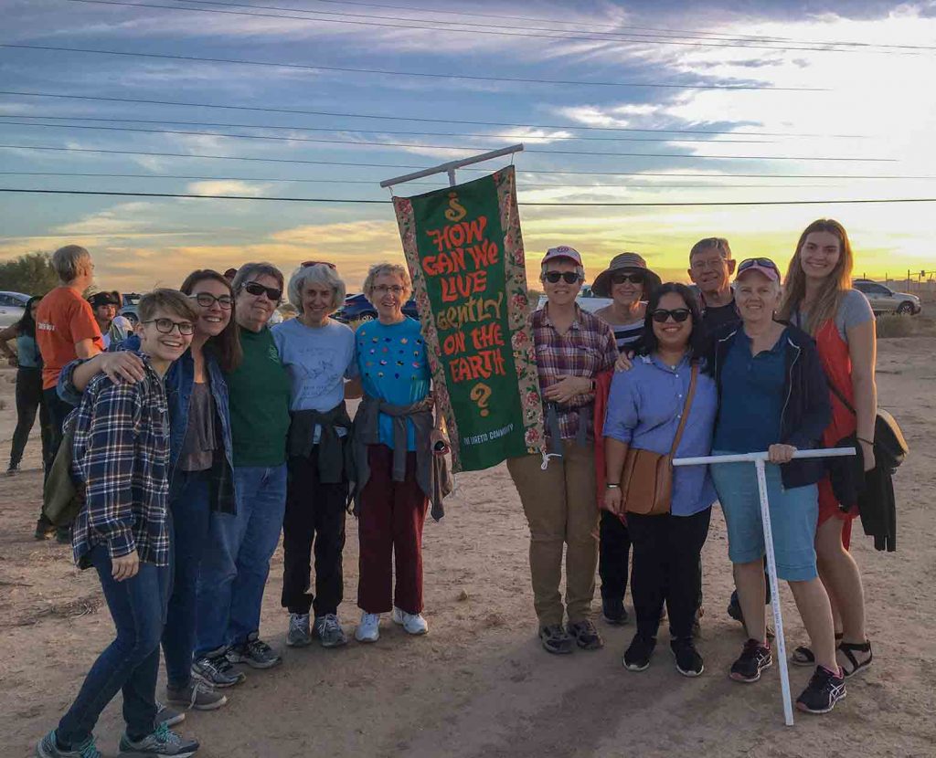 SLs, CoLs and Loretto Volunteers stand around a banner advocating for being gentle with the earth.