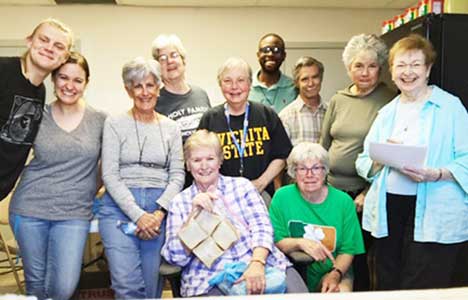 Vivian Doremus, at far right, and her sister Judith Powers, holding a bag of sandwiches,
gather with volunteers and the site coordinator at Casa Oscar Romero in El Paso, Texas. (Photo courtesy of Vivian Doremus)
