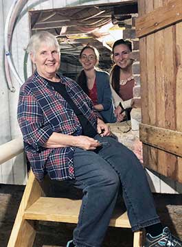Above, from left, Heritage Center Archives and Museum Director Eleanor Craig, Curator Susanna Pyatt and Archivist Ayla Toussaint explore the crawl space beneath the Heritage Center.