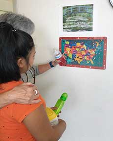 A volunteer points out California on a map of the United States. (Photo courtesy of Vivian Doremus)