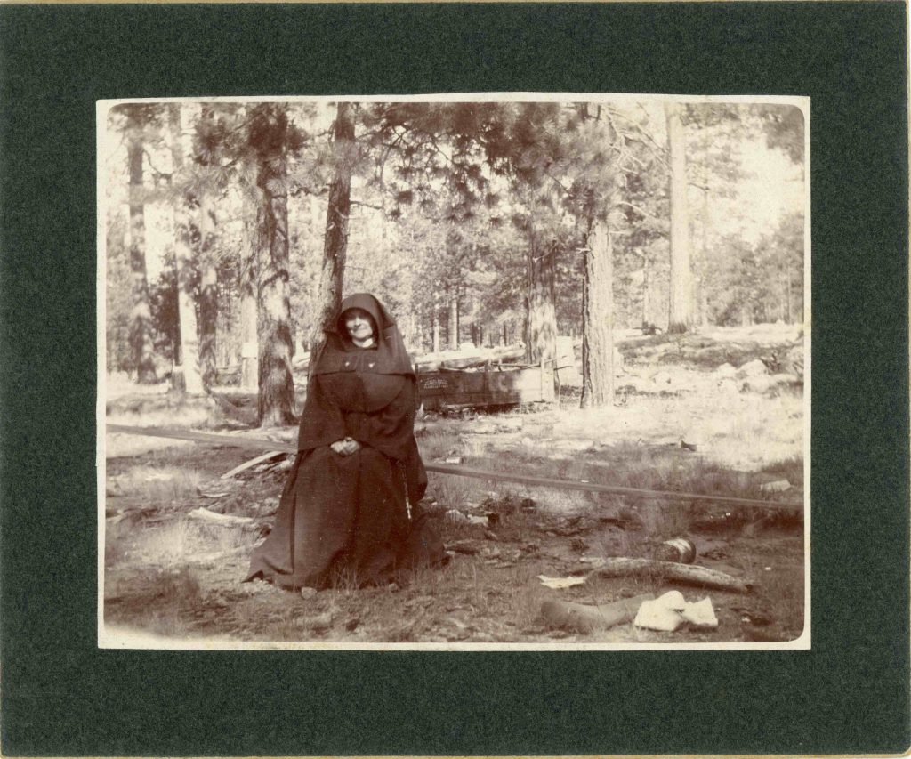 Sister M. Victor McCormick sitting in the woods.