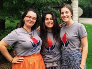 Three Loretto Volunteers standing with arms around each others' shoulders