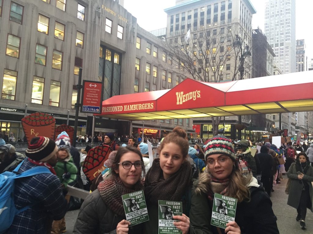 Three Loretto Volunteers stand in front of Wendy's in support of National Farm Workers' movement