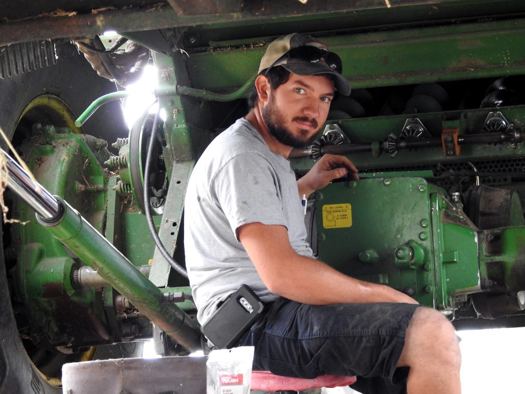 Man working on farm tractor