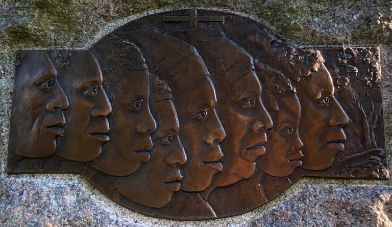 Carved faces on a bronze plate mark the Slave Memorial at the Loretto Motherhouse.