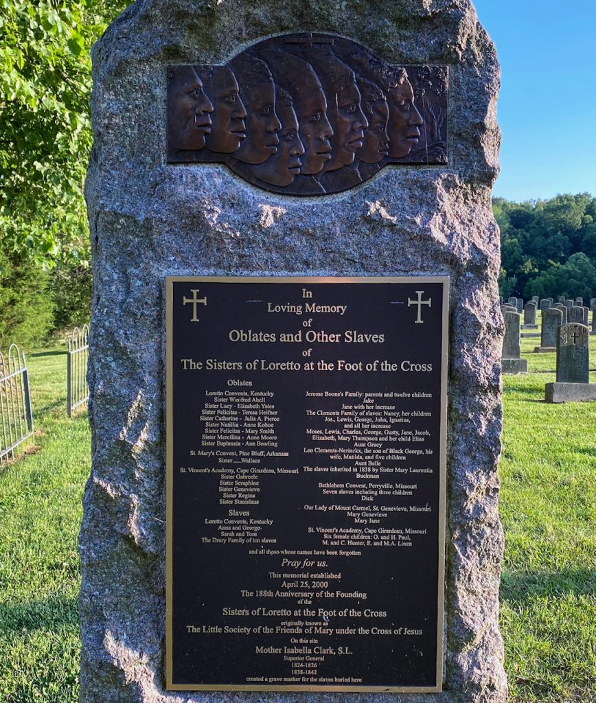 A stone memorial with bronze plaque that reads "In Loving Memory of Oblates and Other Slaves of The Sisters of Loretto at the Foot of the Cross"