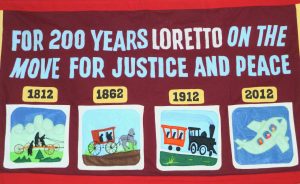 Banner reads "For 200 years Loretto on the move for justice and peace."