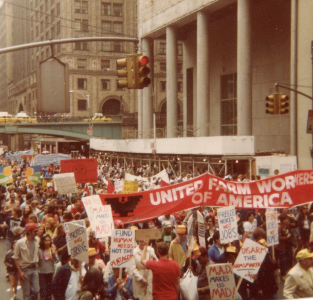 Protest march with people carrying a banner reading "United Farm Workers of America"