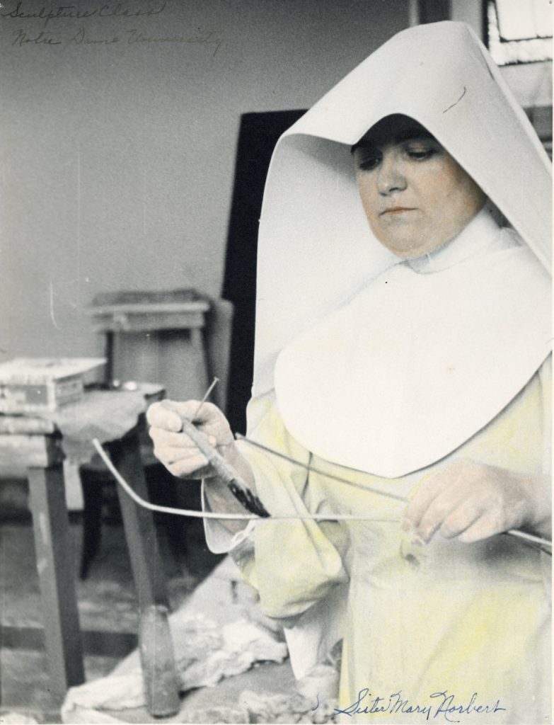A habited nun works on an art project in this archival photo