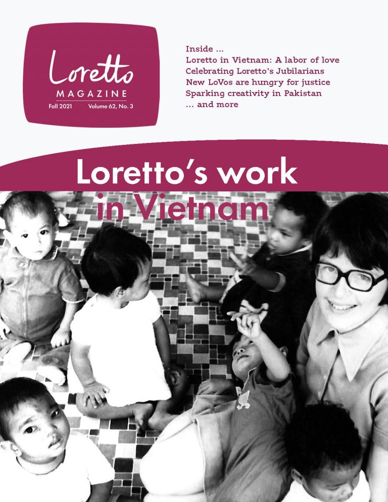Cover of Loretto Magazine Fall 2021 features an archival photo of a Sister of Loretto on the floor with Vietnamese children.