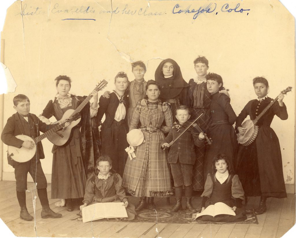 Archival photo of a Sister of Loretto with her class in 1890