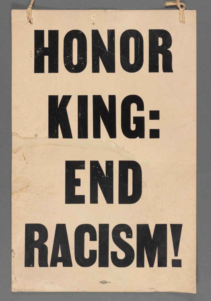 Placard reading "Honor King: End Racism!"
