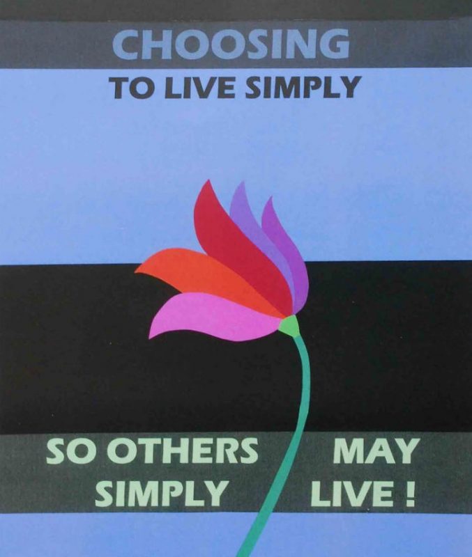 Handcut felt banner displays strips of blue, gray and black, in the center of which is a colorful flower. Text reads "Choosing to live simply so others may simply live!"