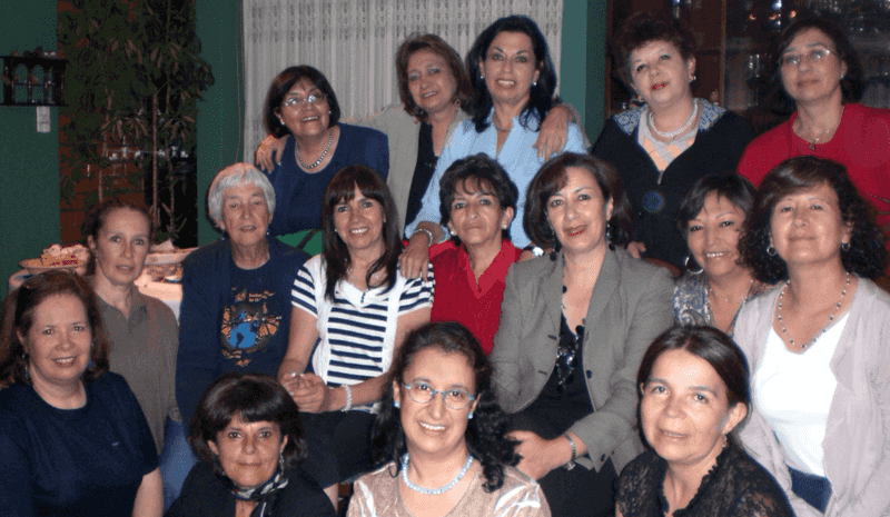 A group of 16 women gather for a photo.