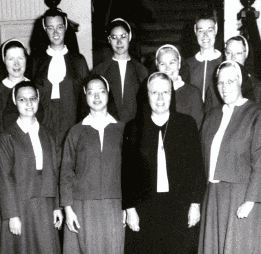 Archival photo of ten nuns in habits posing for a photo.