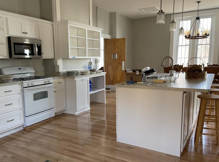 Sunlight streams into a kitchen with center island
