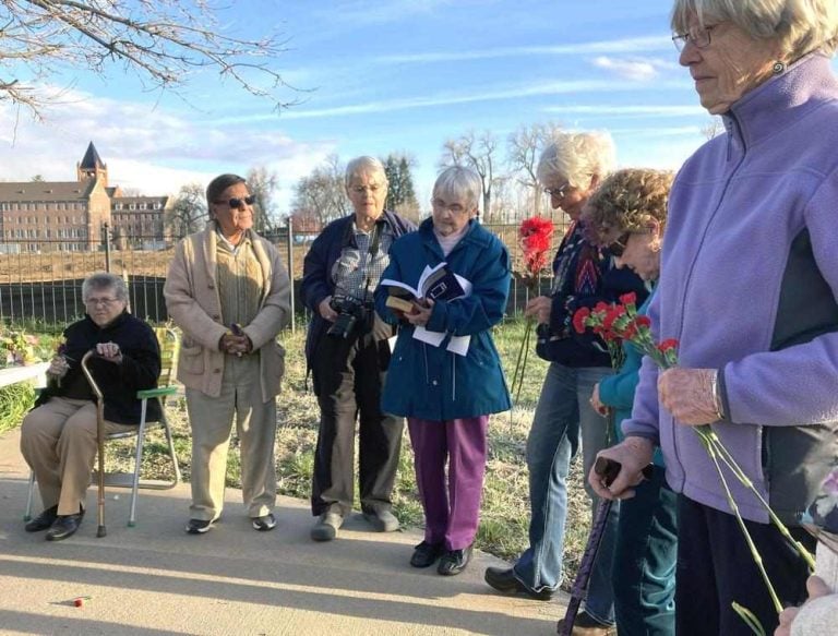 7 men and women, gathered for prayer, in the autumn.