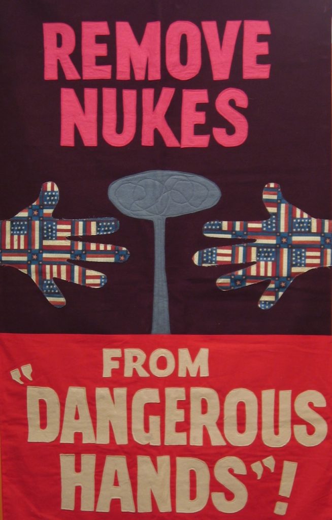 a banner that says "Remove Nukes from Dangerous Hands"