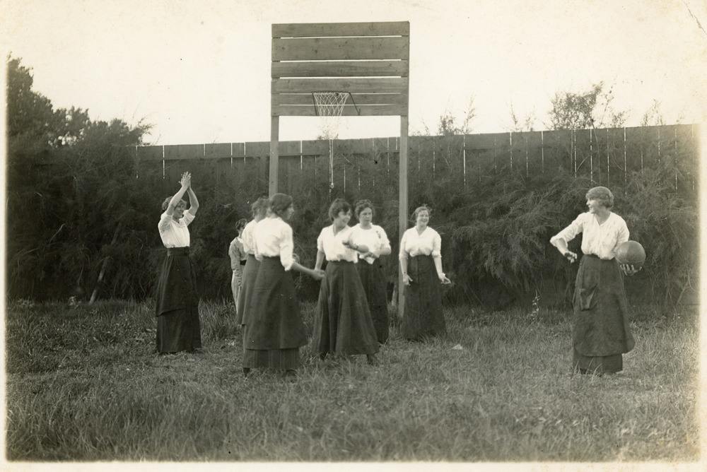 Archival photo of students playing basketball 