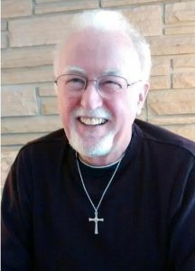 Joyful pastor headshot.