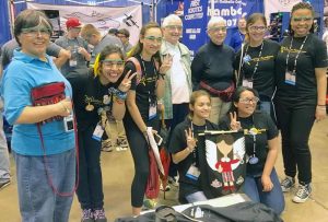 A STEM Club celebrating a successful tournament with a group photo.