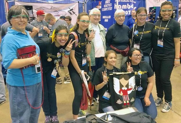 A STEM Club celebrating a successful tournament with a group photo.