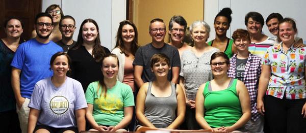 A wide variety of individuals collect together for a group picture during a retreat.
