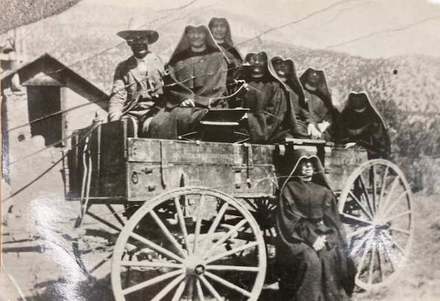 Sisters of Loretto with a driver on a horse drawn wagon used in our early Bernalillo days
