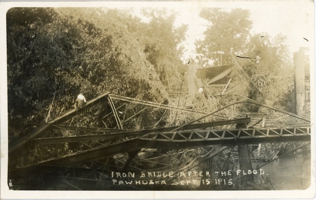 black and white photo of damaged bridge thanks to a flood.