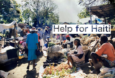 Haiti's Port-Au-Prince marketplace scattered with buyers and sellers on a sunny day.