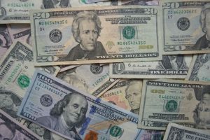 Photo of United States 20 and 100 dollar bills in a pile.