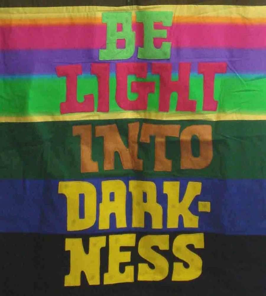 Colorful banner reads, "Be light into darkness"
