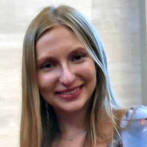 Photo of a young white woman with blonde/brown hair smiling.