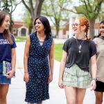Three St. Mary's Academy students of diverse backgrounds walk the campus with St. Mary's Academy President, Ms. Iswari Natarajan.