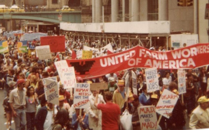 Protest march with people carrying a banner reading "United Farm Workers of America"