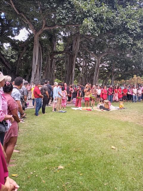 Photo of the crowd of mixed heritage folks from across the Honolulu population; about 100 people. Many are dressed in red in tribute to Lahaina where red is the color of Lahainaluna High School.