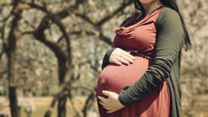 Pregnant woman holds her belly