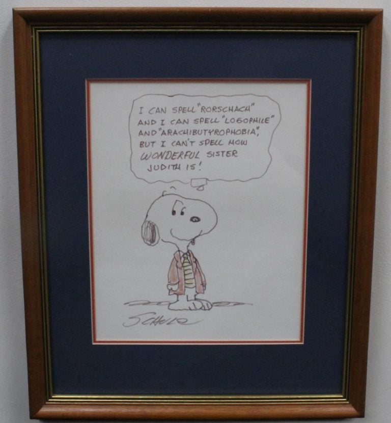 A framed original Snoopy cartoon, signed by Charles Schulz. Snoopy wears a coat and tie and his thought bubble reads "I can spell "Rorschach" and I can spell "Logophile" and "Arachibutyrophobia" but I can't spell how WONDERFUL Sister Judith is!"