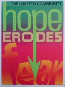 A colorful sign that says hope erodes fear in a gradient from blue, green, pink and orange.