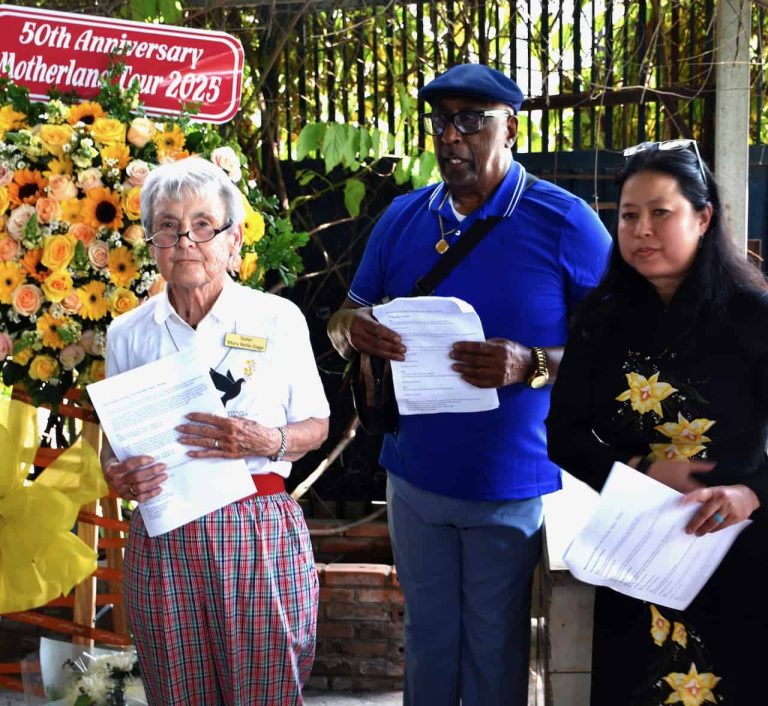 An older white woman, an older Black man and a middle aged Vietnamese woman are pictured attending a memorial service for victims of a plane crash.