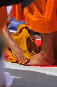 Person washing monk's feet