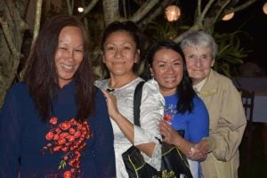 Three Vietnamese former adoptee women and a religious sister smile for a photo.