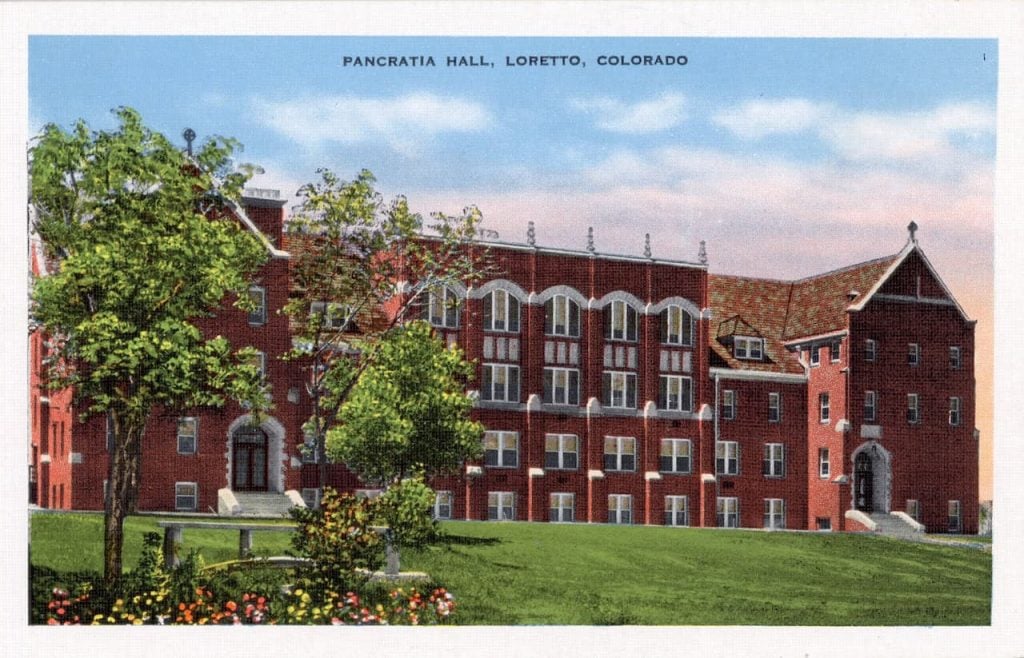A postcard of a red brick building that used to house students and classrooms.