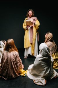 man and people in jesus christ and apostles costumes