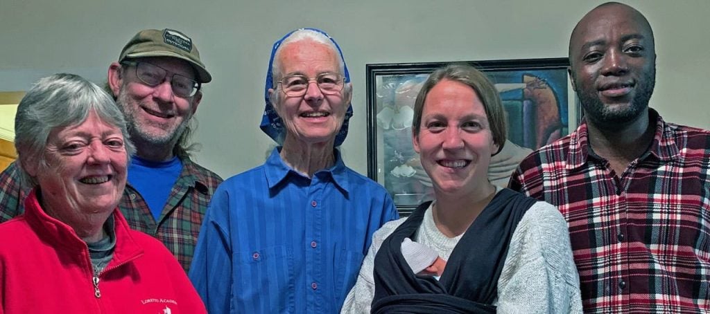 A group of five people smiling together. They were all part of the same Catholic Worker House at one point.
